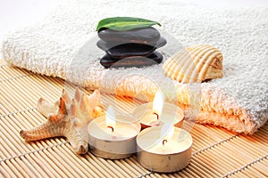 Foldet white bath towel and zen stones