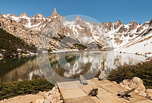 Folding chairs at glacial lake in Andes