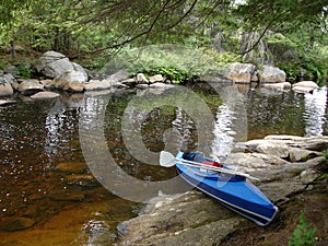 Folding kayak by shore photo