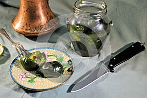 Folding knife stainless steel sharp blade aluminum black handle food fig jam close up still life background