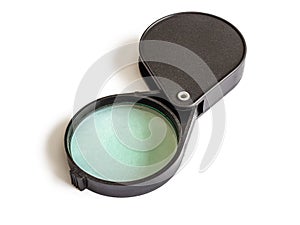 Folding magnifier in a black plastic case