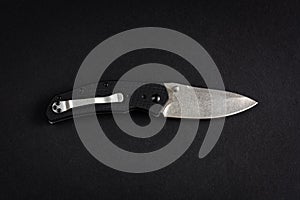 Folding pocket knife isolated on a black background