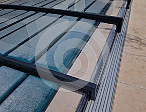 folding pool roof. the cover made of aluminum and plexiglass runs photo