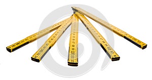 Folding ruler isolated, yellow carpenter`s rule with centimeters numbers.