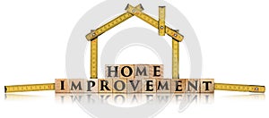 Folding ruler in the shape of a house and wooden text Home Improvement