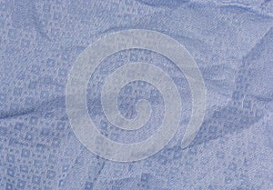 Folds of blue fabric textured background close up