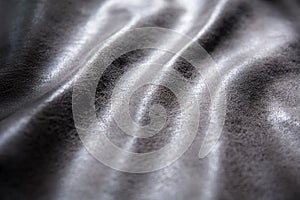 The folds of the fabric with the invoice are illuminated by light