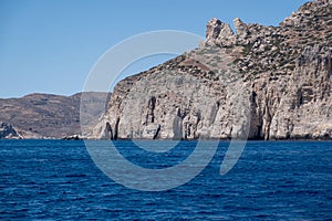 Folegandros island, Vorina bay, Cyclades, Greece. High cliff, Aegean ripple sea, clear blue sky