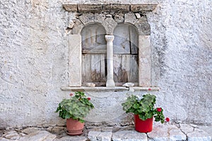 Folegandros island, Windows of an old church at Chora town square. Greece, Cyclades