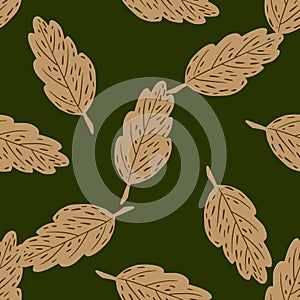 Foliage seamless random pattern with beige leaf silhouettes. Green background