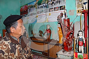 The folk artist of Thanh Hai water puppetry inside wooden puppet