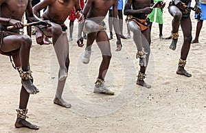 Folk dance on the sand. Feet of dancing Africans on a sandy surface