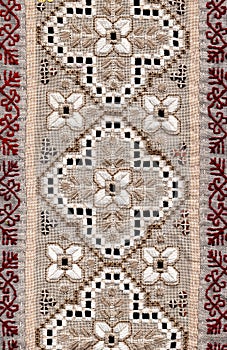 Folk handmade embroidery at natural linen.