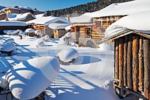 The folk houses in white snow and blue sky