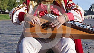 Folk musician with music instrument gusli