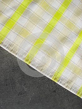Folk pattern, tablecloth on stone table. Checkered tablecloth. Stone kitchen top covered with a napkin