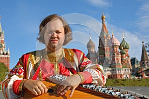 Minstrel playing an old Russian musical instrument gusli