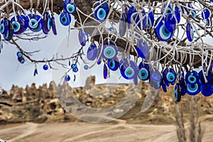 Folk Turkish talismans from the evil eye are hung over the trees in the Cappadocia