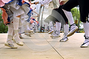 Folkloric dance. Men and women dancing in traditional costumes