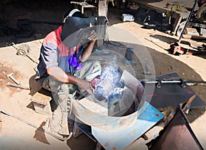 Folkway steel mechanic working at little garage