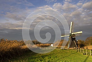 The Follega windmill under a heavy clouded sky