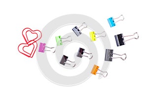 Follow the heart made by multicolored paper clip binders isolate