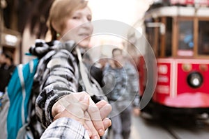 Follow me Concept Woman pulling Man Hand toward Train