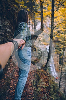 follow me concept woman walking by trail to forest waterfall