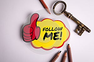 Follow Me. Sticker with text on white office table