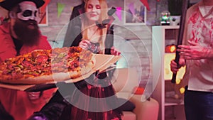 Follow shot of witch girl arriving with pizza