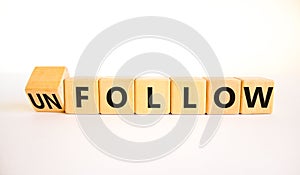 Follow or unfollow symbol. Turned wooden cubes and changed concept words Follow to Unfollow. Beautiful white table white