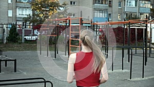 Follow-up shot of slim young fitness runner in sportswear running to sports ground