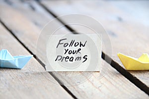 Follow your dreams text written on a tag
