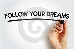 FOLLOW YOUR DREAMS underlined text with marker, concept background