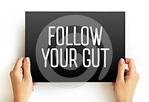Follow Your Gut text on card, concept background