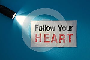 Follow your heart - inscription on a white card