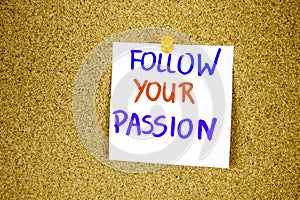 follow your passion on Sticky note with inscription pinned on a cork bulletin board