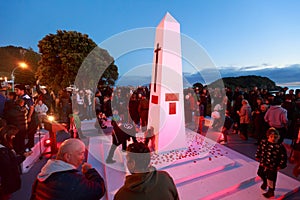 Anzac Day 2018, Mount Maunganui NZ: People lay poppies around the base of the cenotaph