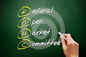 FOMC - Federal Open Market Committee acronym, business concept on blackboard