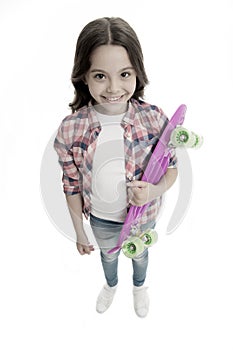 Fond of skateboarding. Kid girl happy carries penny board. Child likes skateboarding with penny board. Modern teen hobby