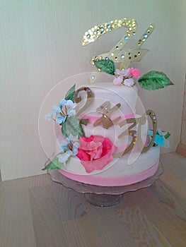 Fondant cake for birthday with sugar roses, hydrangea and topper in white, blue and pink colors