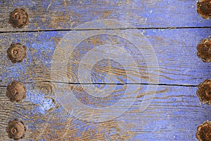 Violet blue wooden background with rusty nails and cracks photo