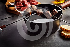 Fondue Forks of Cooked Beef with Pot of Hot Oil