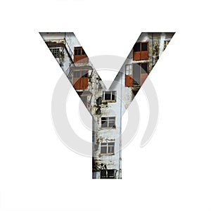 Font on an abandoned industrial building. The letter Y cut out of paper on a background of windows and doors of an abandoned