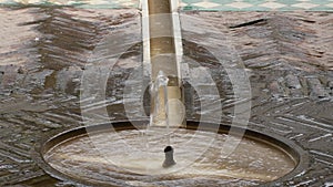 Font pouring water in a nasrid courtyard of the Alcazaba, Malaga, Spain