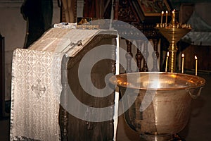 Font with three candles for the sacrament of Epiphany. Orthodox Church