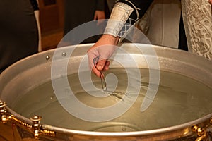 Font with water for baptism in Orthodoxy. Christian ritual of the consecration of Christ