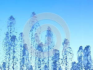 Fontain waterdrops on blue sky background