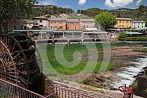 Fontaine-de-Vaucluse, Provence-Alpes-Cote d`Azur, France: landscape of the village with the green Sorgue river