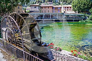 Fontaine de Vaucluse, Provence, France. Old waterwheel on the river.